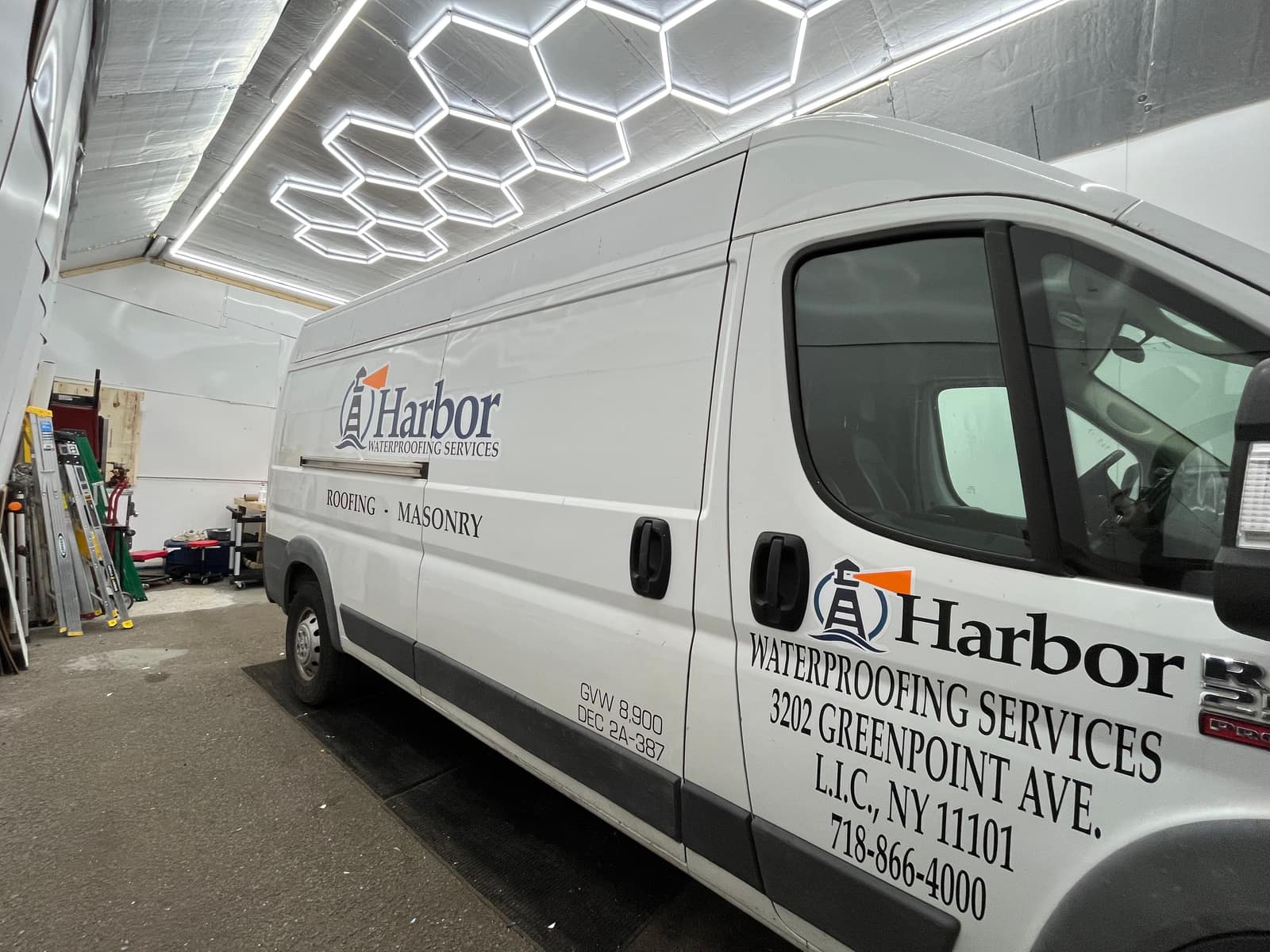 White Ram ProMaster for Harbor Waterproofing Services with a cut vinyl logo and Roofing and Masonry lettering on the side, in the NYC Car Wraps shop