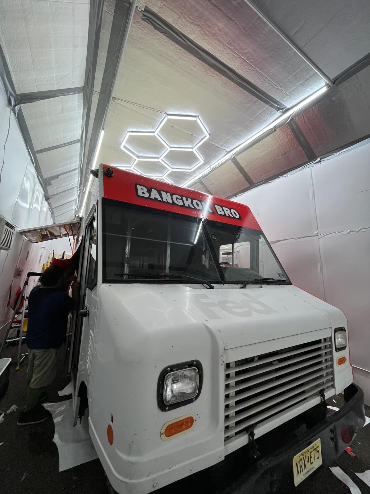 Bangkok Bro food truck earlier in the install with the red wrap on the cab and the box still white