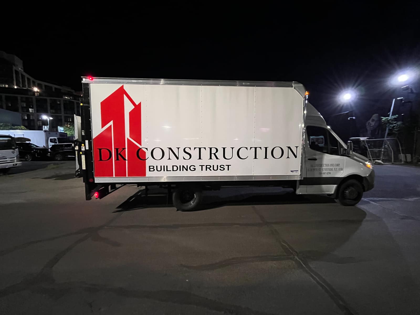 DK Construction box truck with a printed side graphic, wrapped by NYC Car Wraps