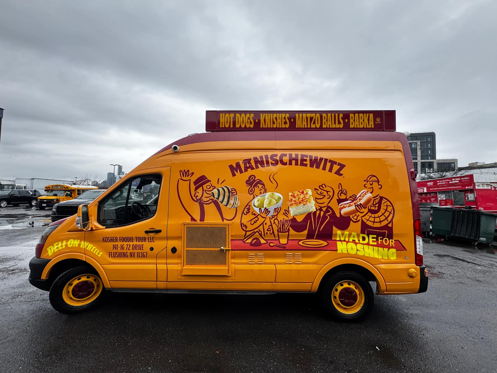 Yellow Manischewitz van with illustrated characters and Honk if you're a nosher art, outdoors