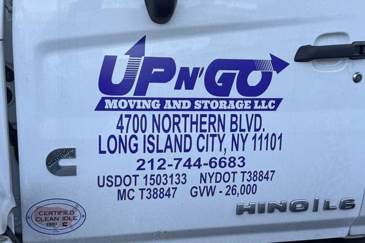 Close-up of the Up N' Go Moving and Storage cab door lettering with the 4700 Northern Blvd Long Island City address, phone number, USDOT, NYDOT, MC and GVW numbers