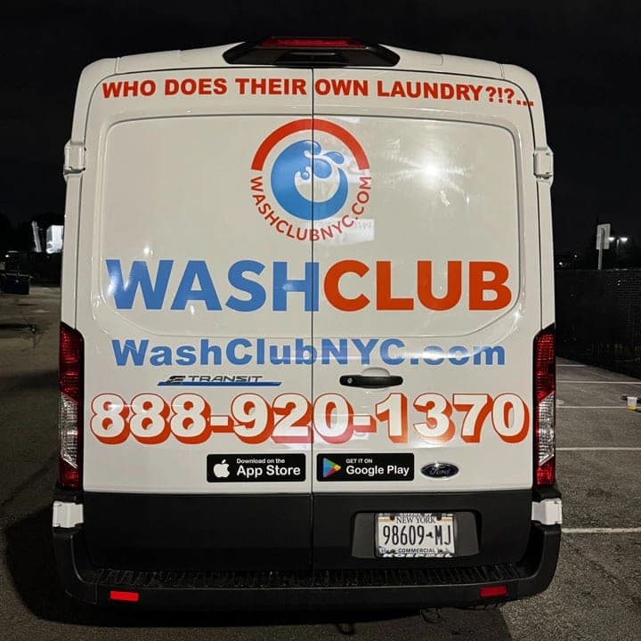 Rear doors of a white WashClub NYC Ford Transit with the line Who does their own laundry?!?, the logo and a phone number