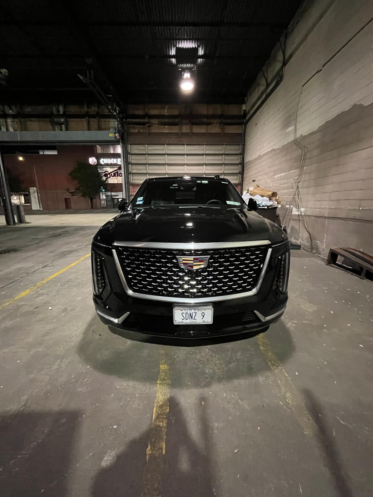 Before — unwrapped Cadillac Escalade in the bay