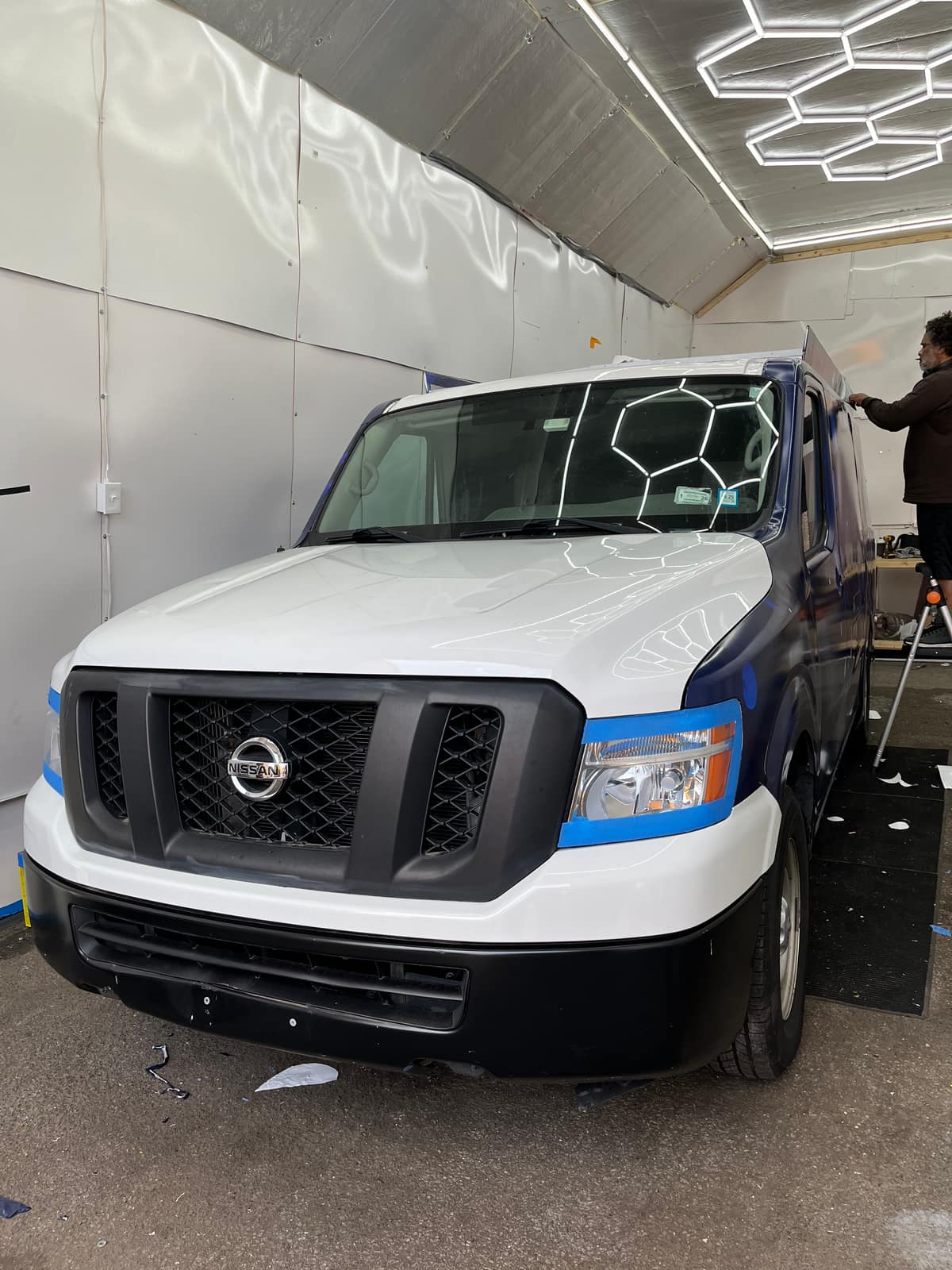 Nissan NV cargo van being wrapped in the NYC Car Wraps installation bay