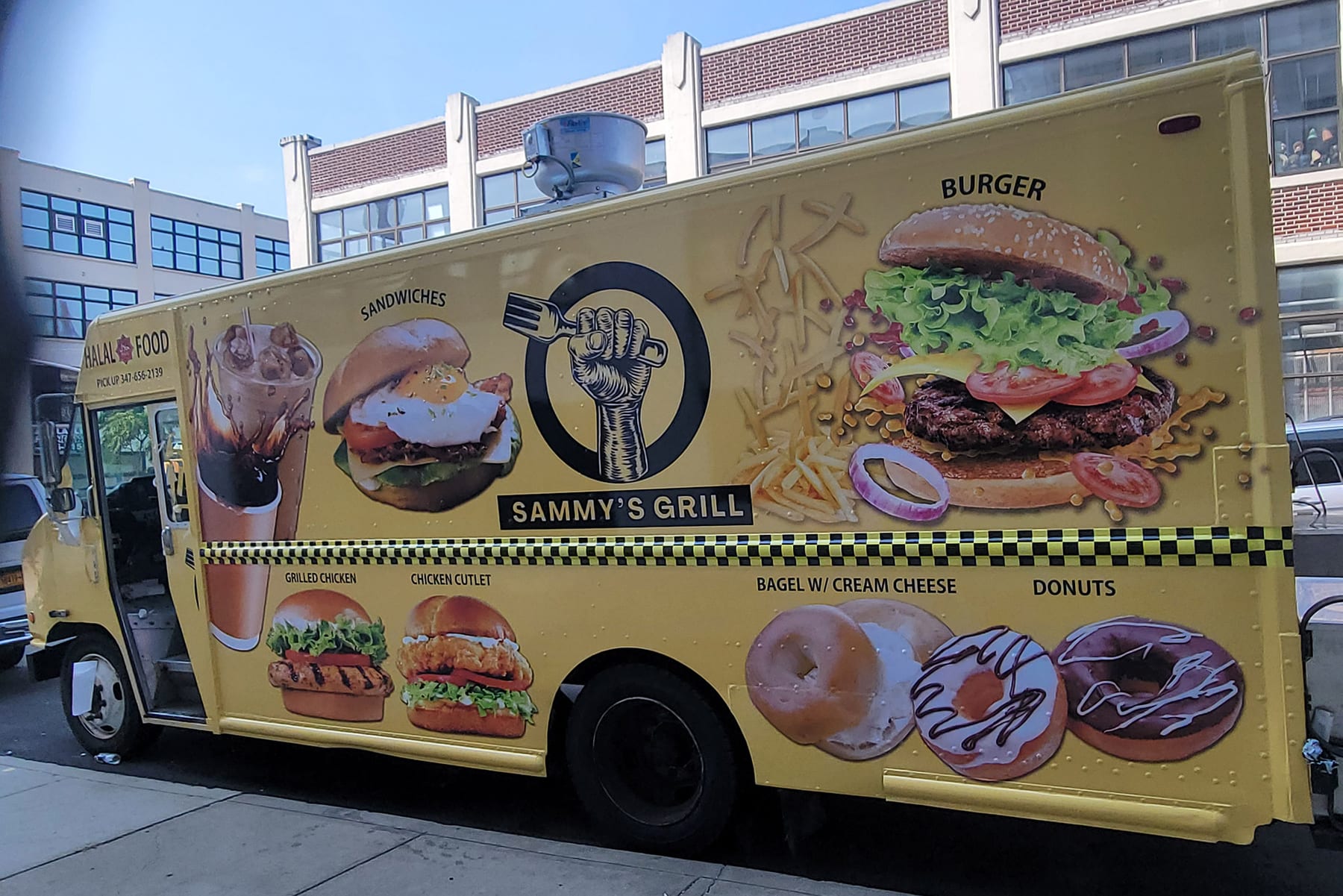 Yellow Sammy's Grill food truck with a printed wrap showing burger, bagel and donut photos, side view